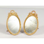 A GOOD PAIR OF OVAL ORMOLU PHOTOGRAPH FRAMES. 6ins x 3.5ins.