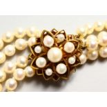 A DOUBLE ROW PEARL CHOKER with gold and pearl clasp.