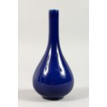 A SMALL DARK BLUE GROUND BOTTLE VASE. 6ins high.