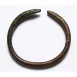 A ROMAN BRONZE BANGLE WITH SNAKE HEAD.