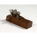 A JAPANESE BRONZE MODEL OF A CARPENTERS PLANE. 3.5ins long.