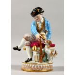 A 19TH CENTURY MEISSEN PORCELAIN FIGURE OF A BOY, seated on a stool holding a gun, dog by his