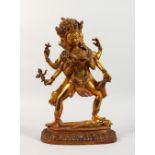 AN EASTERN GILT BRONZE STANDING DEITY, inset with coral and turquoise. 11.5ins high.