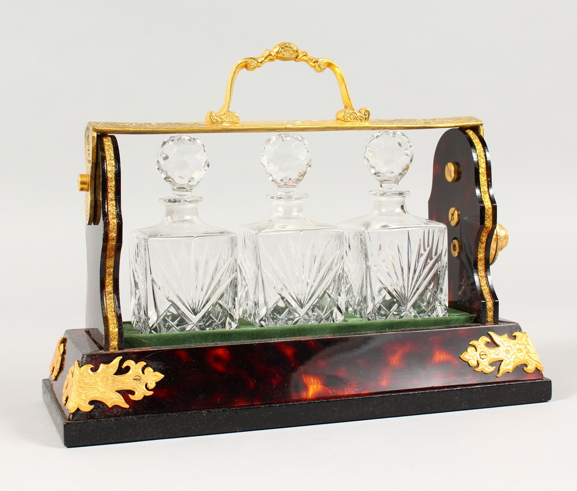 A MINIATURE FAUX TORTOISESHELL AND ORMOLU MOUNTED TANTALUS. 10.5ins wide.