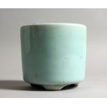 A CELADON GROUND CIRCULAR BRUSH POT. 4ins high.