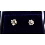 A PAIR OF WHITE GOLD DIAMOND STUD EARRINGS of 80 points approx.