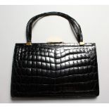 A LADIES BLACK CROCODILE LEATHER HANDBAG.