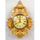 A CARVED GILTWOOD CARTEL WALL CLOCK. 20ins high.