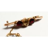 A GARNET AND TOPAZ BAR BROOCH.