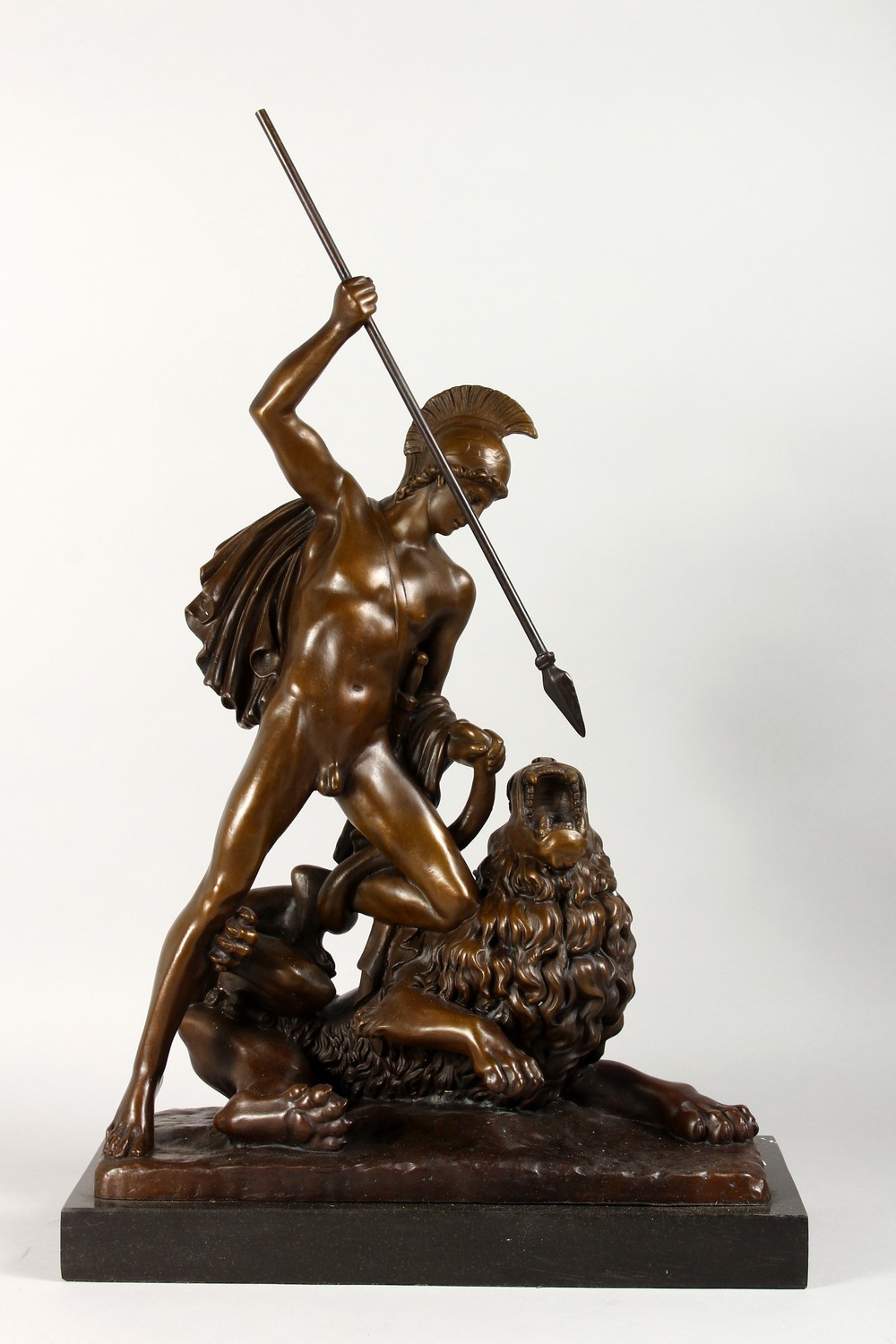 A GOOD BRONZE CLASSICAL GROUP, a Roman gladiator spearing a lion, on a marble base. 24ins high.