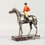 A HORSE AND JOCKEY on a marble base. 8ins high.