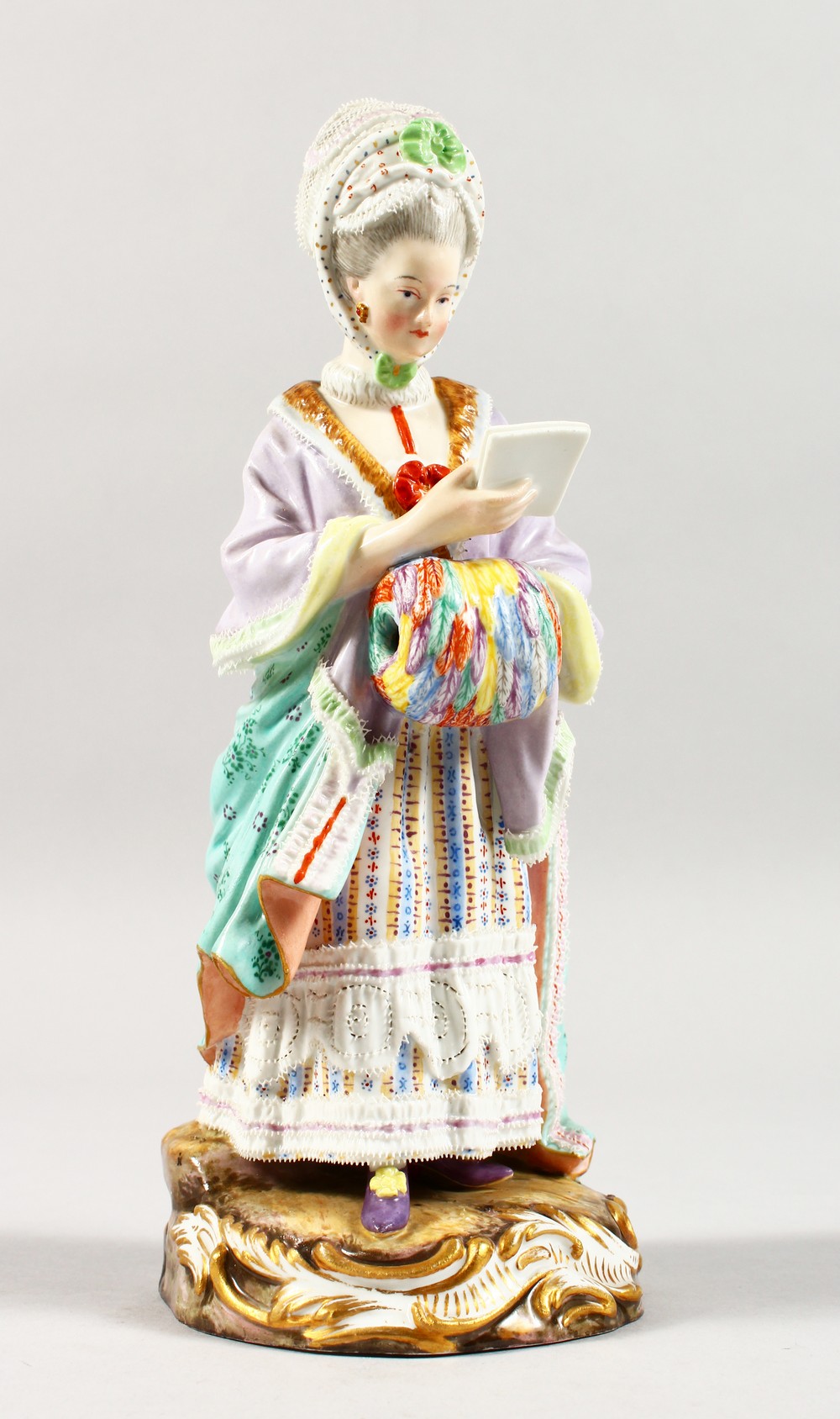 A GOOD 19TH CENTURY MEISSEN PORCELAIN FIGURE OF A LADY with muff, reading a book. Cross swords