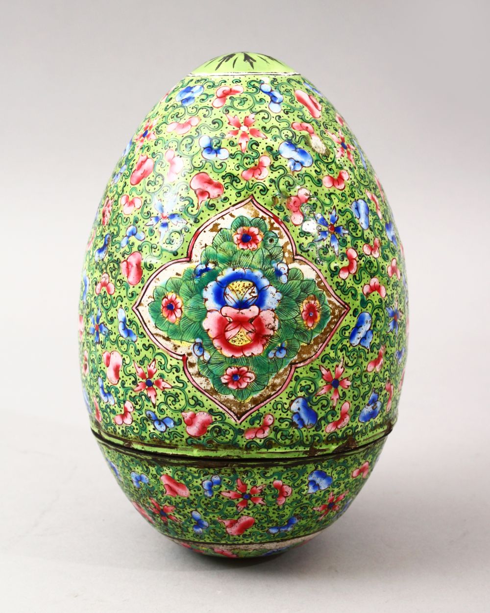 A GOOD 19TH CENTURY CHINESE CANTON ENAMEL EGG, the egg with a green ground with floral panel