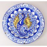 A GOOD LARGE ISLAMIC SPANISH BLUE AND WHITE POTTERY DISH, depicting a winged serpent with