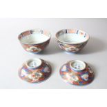A PAIR OF JAPANESE MEIJI PERIOD IMARI PORCELAIN BOWLS AND COVERS, painted with alternating panels of