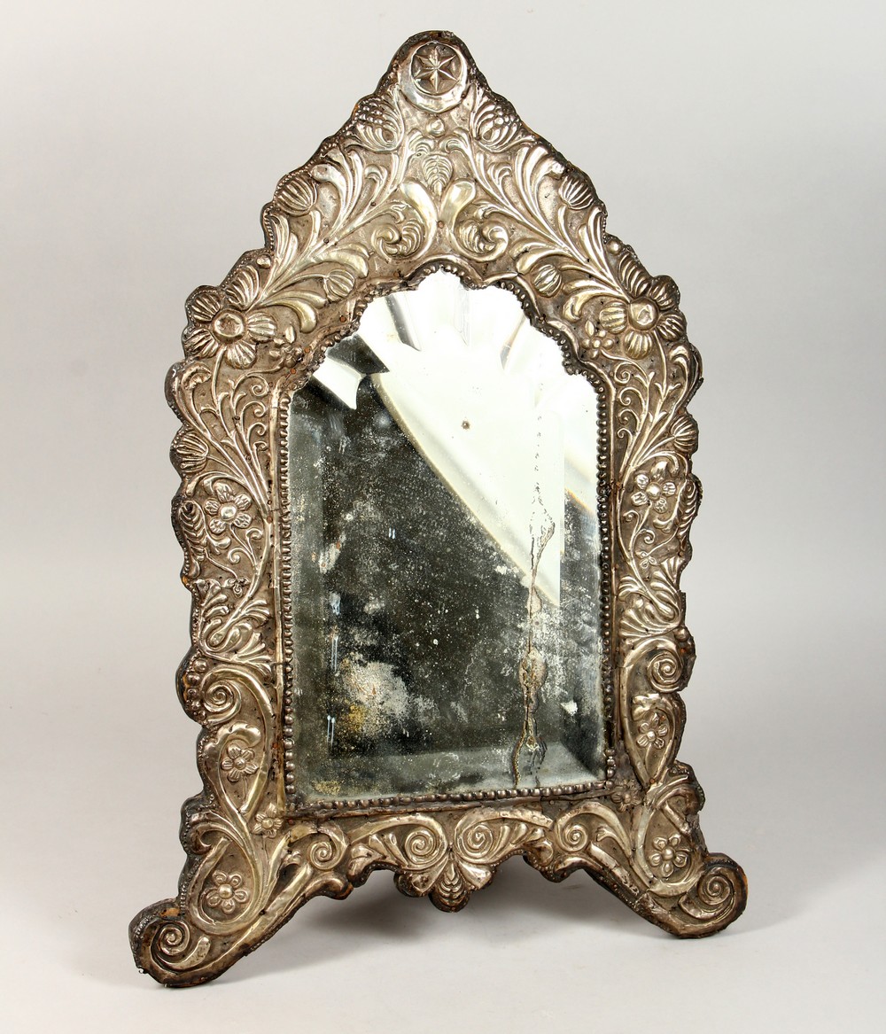 A GOOD 18TH CENTURY OTTOMAN SILVER BEVELLED GLASS MIRROR, the frame with embossed scrolling foliage,