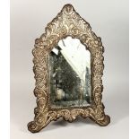 A GOOD 18TH CENTURY OTTOMAN SILVER BEVELLED GLASS MIRROR, the frame with embossed scrolling foliage,