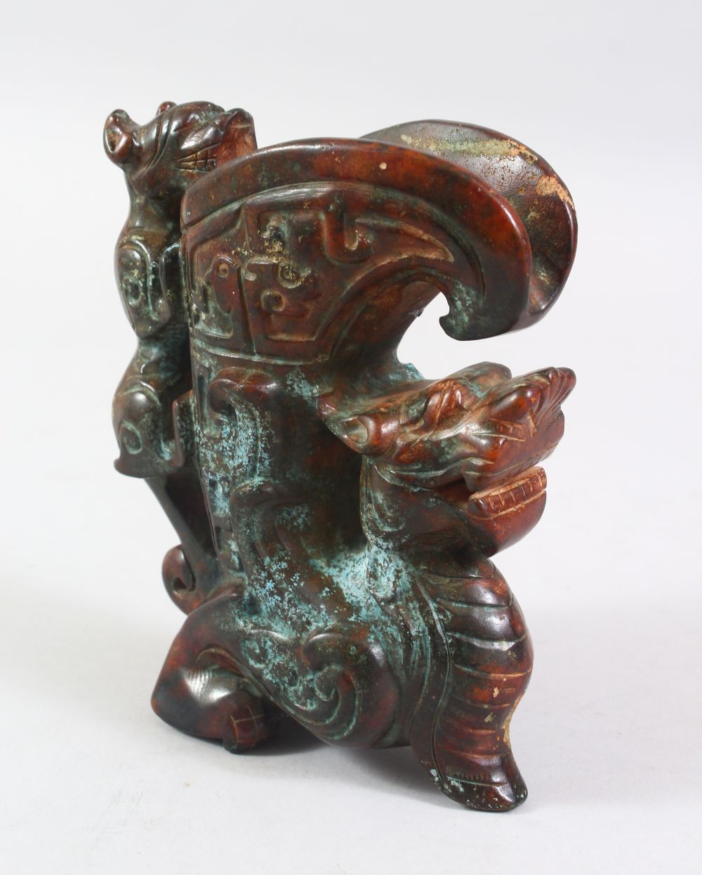 A 20TH CENTURY CHINESE ARCHAIC STYLE CARVED HARDSTONE EWER, the body carved as a dragon, the