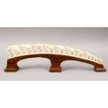 A GOOD 19TH CENTURY INDIAN CARVED IVORY BRIDGE GROUP OF ELEPHANTS, housed on a carved wooden base,
