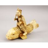 A JAPANESE MEIJI PERIOD CARVED IVORY OKIMONO OF A CARP AND MAN, the okimono carved in the form of