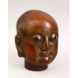 A GOOD CHINESE CARVED WOOD & LACQUER HEAD OF BUDDHA, With traces of gilding, 22cm high.