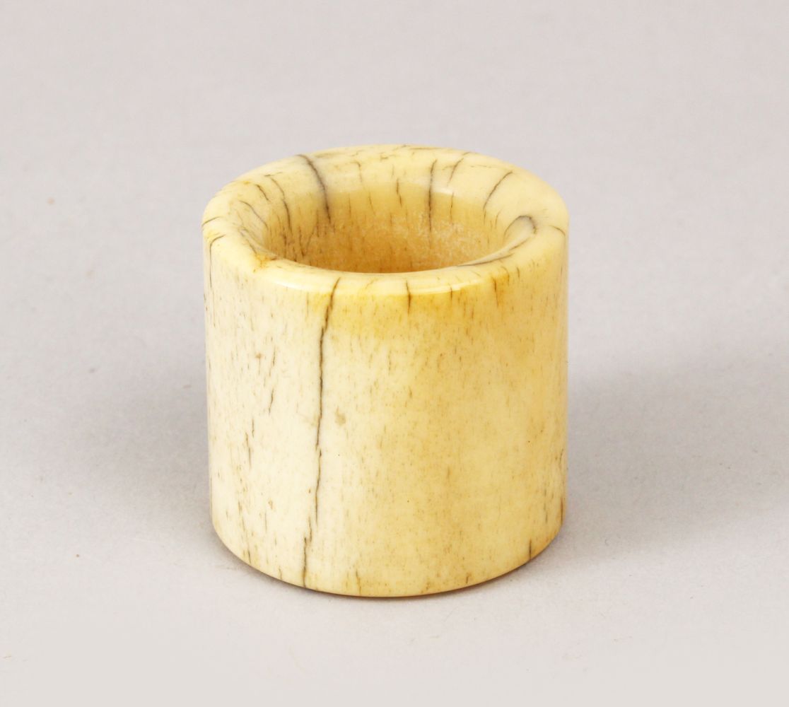 A GOOD 19TH CENTURY CHINESE CARVED IVORY ARCHERS RING, 3cm x 3cm.