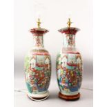 A GOOD PAIR OF 19TH CENTURY CHINESE FAMILLE ROSE PORCELAIN VASES / LAMPS, the body profusely