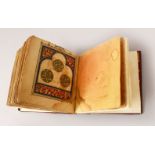A SMALL 19TH CENTURY OR EARLIER LEATHER BOUND AFRICAN ISLAMIC PRAYER BOOK, with finely decorated