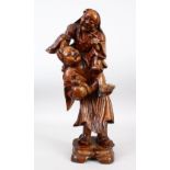 A LARGE 19TH / 20TH CENTURY CHINESE CARVED HARDWOOD FIGURE OF TWO MEN, one upon the shoulders,