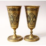 A GOOD PAIR OF 19TH / 20TH CENTURY PERSIAN CHASED CALLIGRAPHIC BRASS STEM CUPS, with panelled