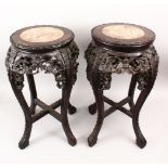 A PAIR OF 19TH CENTURY CHINESE CARVED HARD WOOD & MARBLE TOPPED PLANT STANDS, the top inset with