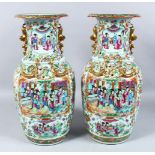 A GOOD PAIR OF 19TH CENTURY CHINESE CANTON FAMILLE ROSE PORCELAIN VASES, the body of the vases