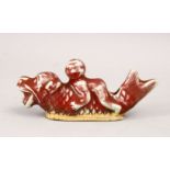 A RARE CHINESE KANGXI PORCELAIN WATER DROPPER OF A BOY UPON MYTHICAL FISH, the fish with a boy