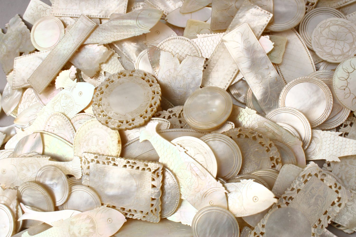 A QUANTITY OF 19TH CENTURY CHINESE CARVED MOTHER OF PEARL GAME COUNTERS, various styles an sizes.