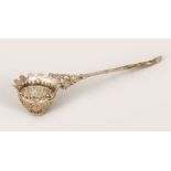 A 19TH CENTURY INDIAN SILVER FILIGREE TEA STRAINER, 17cm long.