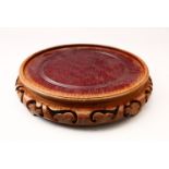A GOOD 19TH CENTURY CHINESE CARVED HARDWOOD STAND, 25cm diameter housing a vase no larger than