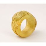 A GOOD CHINESE CARVED HARD STONE / JADE LIKE ARCHERS RING, with carved decoration, 4.5cm.