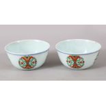 A GOOD PAIR OF CHINESE DOUCAI PORCELAIN TEA BOWLS, with decorated roundel decoratio, the base with a