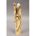 A 19TH CENTURY CHINESE CARVED IVORY FIGURE OF SHOU LAO, stood holding his staff and fruit vine, 25.