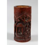 A CHINESE CARVED BAMBOO BRUSH POT, carved with traditional scenes of temples, men and flora, 14cm
