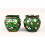 A GOOD PAIR OF 19TH CENTURY CHINESE CLOISONNE ENAMEL CUPS, decorated upon a green ground with scenes