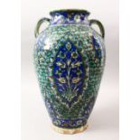 A GOOD PERSIAN QAJAR POTTERY VASE , with twin moulded handles, decorated with panels of flora, 35.