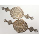 A GOOD PAIR OF ISLAMIC WHITE METAL PIERCED CALLIGRAPHIC PLAQUES, The pair of pierced plaques with