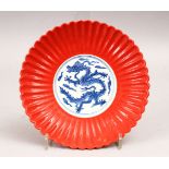 A GOOD CHINESE CORAL GROUND & BLUE AND WHITE DRAGON DISH, the dish in the moulded form of a