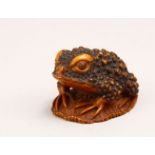 A JAPANESE MEIJI PERIOD CARVED WOOD NETSUKE OF A TOAD - SIGNED, the netsuke depicting a toad