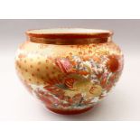 A JAPANESE LATE MEIJI PERIOD KUTANI PORCELAIN BOWL, decorated with an orange ground with scenes of