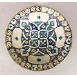 A 12TH/13TH CENTURY ISLAMIC BLUE AND WHITE POTTERY BOWL with stylised flowerhead motifs in a