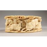 A 19TH CENTURY INDIAN CARVED IVORY TUSK SECTION, deeply carved to depict and array of wild