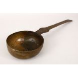 A LARGE BATAVIAN BRONZE STRAINER/LADLE with engraved decoration to the arm, 40.5cm long, the bowl