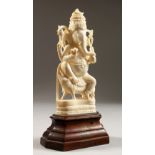 A 19TH CENTURY INDIAN CARVED IVORY FIGURE OF GANESH / GOD, on a timber base, 20cm x 9cm.